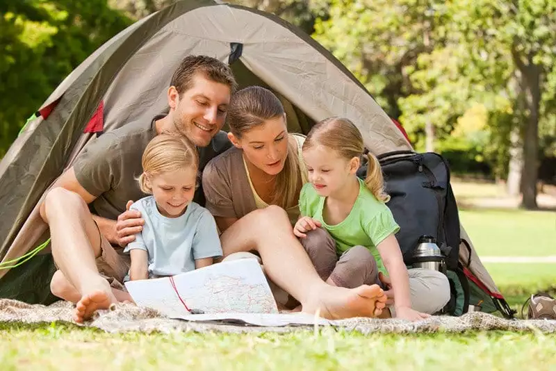 family sitting in front of camping tent at a Gatlinburg campground