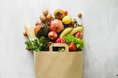 food spilling out of a brown paper bag