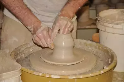 person making pottery