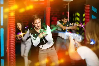 Teenagers playing laser tag