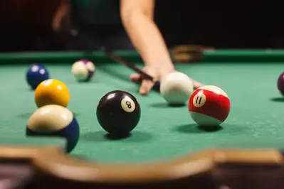 family playing pool in cabin